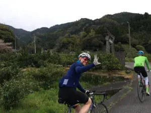 CYCLIST WAVING IN KYOTO
